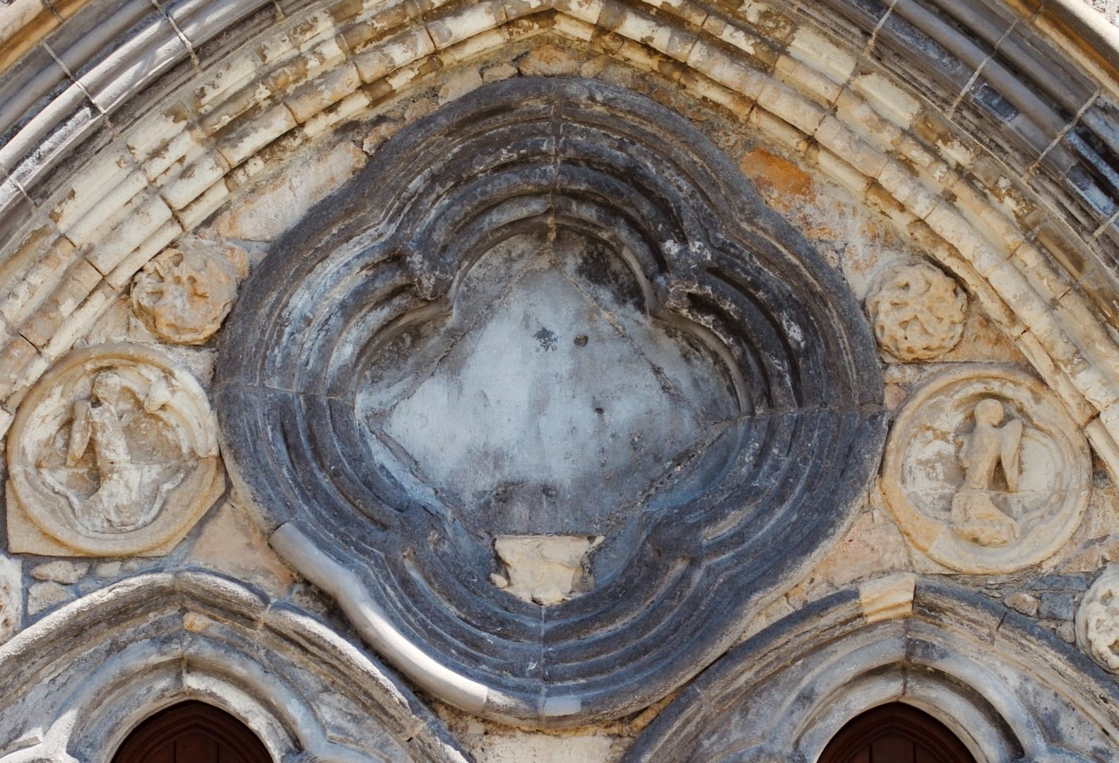 Quatrefoil shape carved into what looks like an old church building