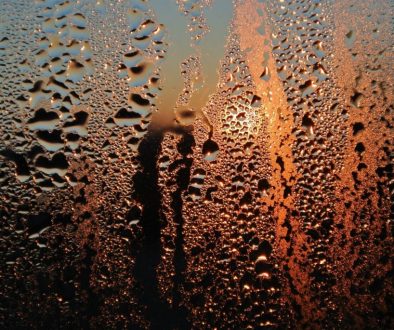 Condensation on window with water droplets running down