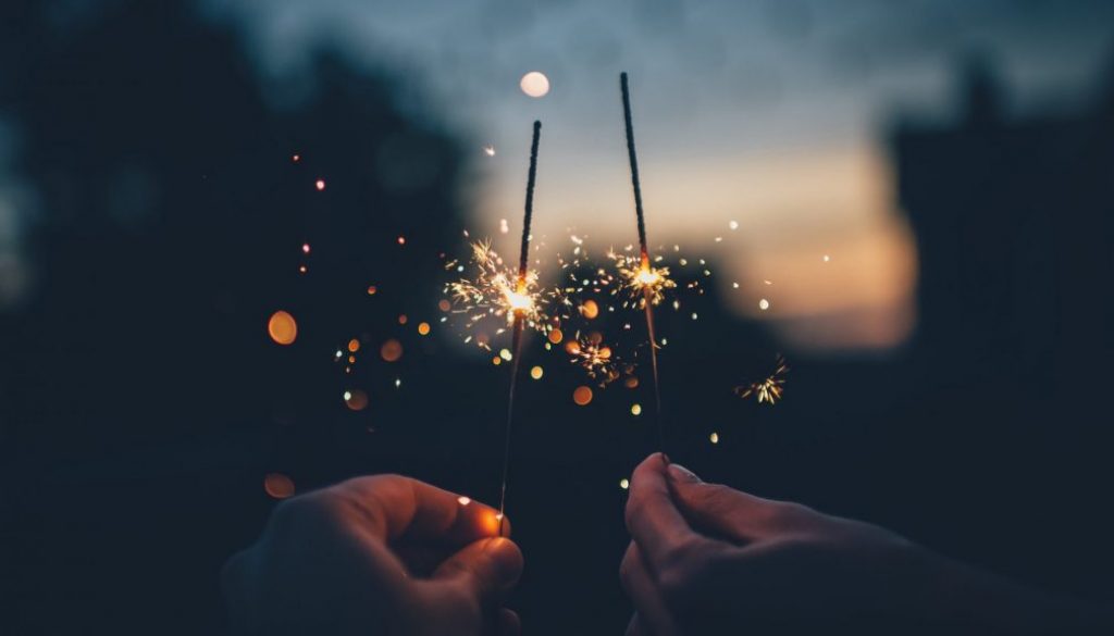 Two people holding sparklers to celebrate new year, a time to get a new inspection done on your home