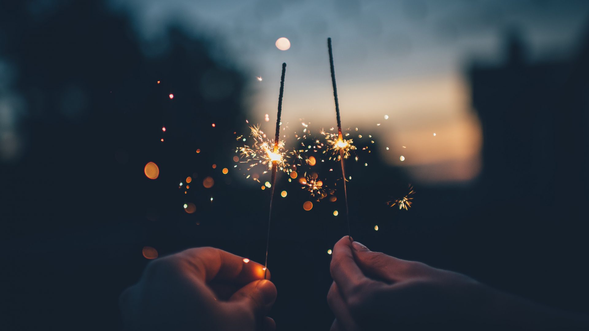 Two people holding sparklers to celebrate new year, a time to get a new inspection done on your home