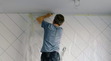 Man carrying out maintenance work on a party wall.