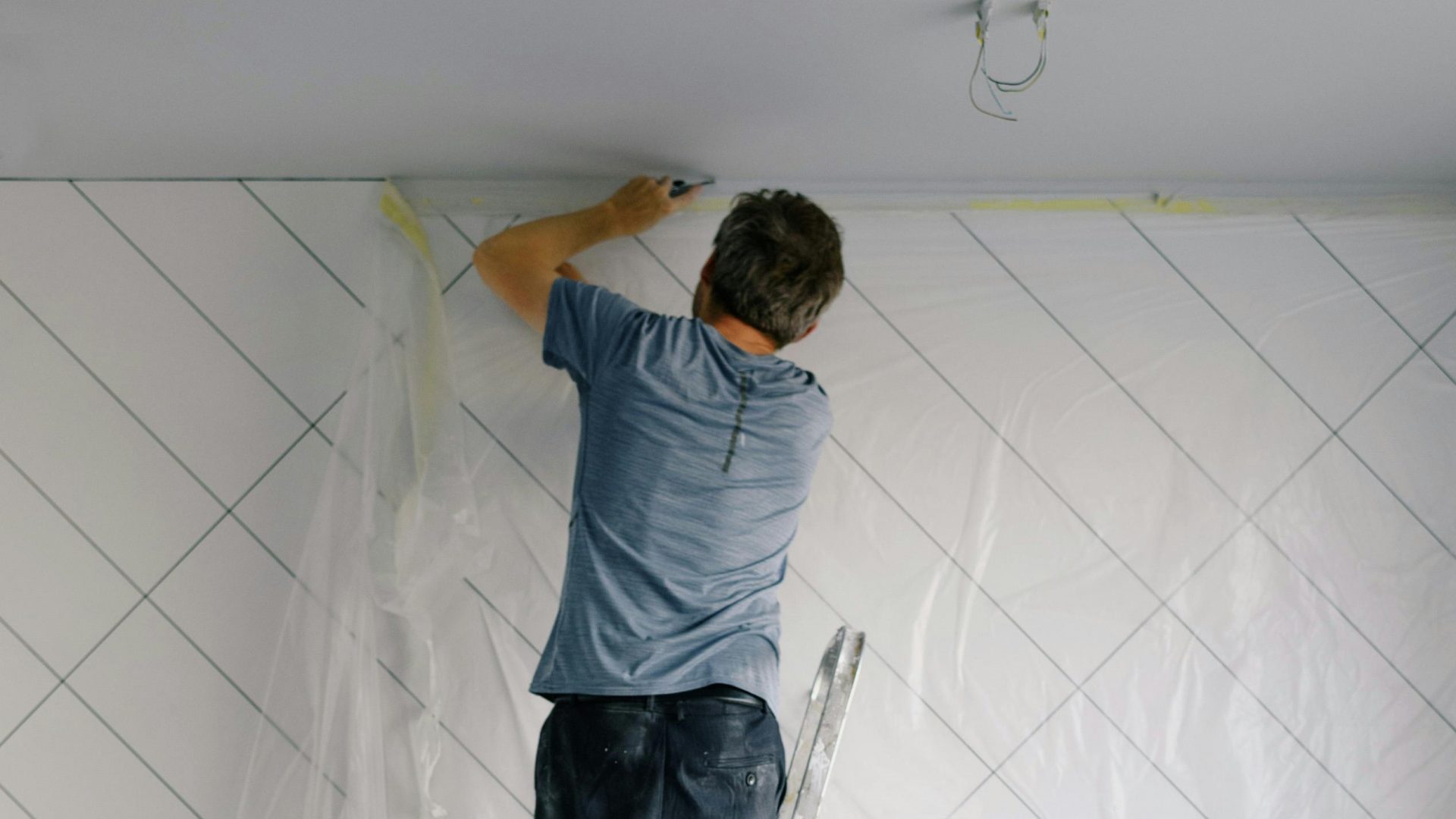Man carrying out maintenance work on a party wall.